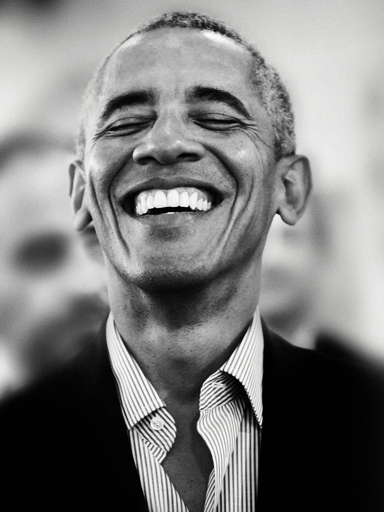 Black-and-white portrait of a smiling man.